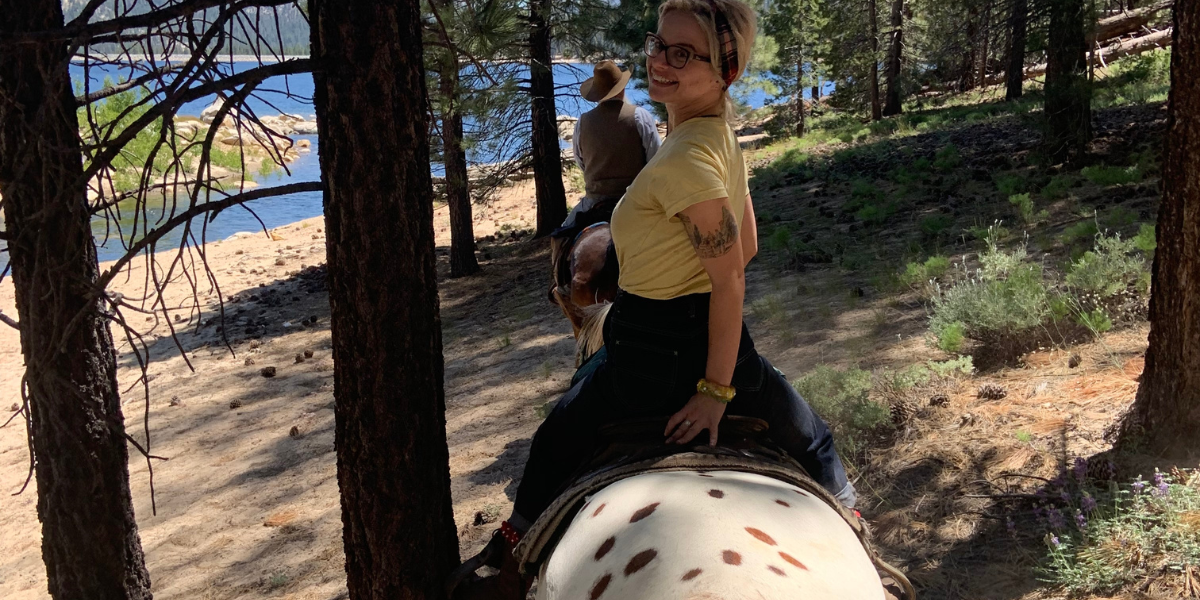 Woman enjoying a horseback trail ride in the Sierra Nevada Wilderness